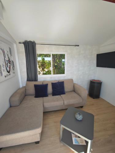a living room with a couch and a table at Casa Azul-Tiny house with fantastic view, big outdoor space and pool in Silves