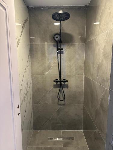 a shower with a shower head in a bathroom at Villa Violand 3 in Limanu