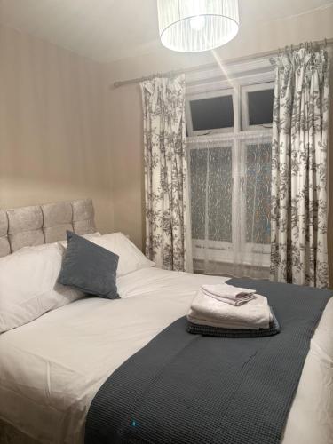 a bedroom with a large white bed with a window at Hideway Dartmouth in Dartmouth