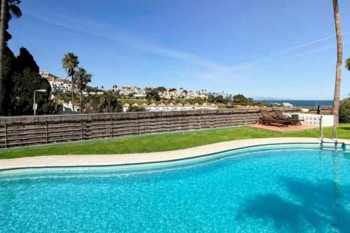 a large blue swimming pool with a view of the ocean at Pool- AirCon- Quiet&Peaceful- FamilyFriendly in Manilva