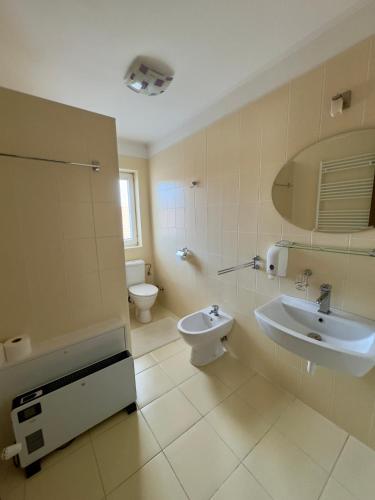 a bathroom with a sink and a toilet at Marilyn Apartman Gyenesdiás in Gyenesdiás