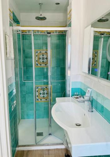 a bathroom with a sink and a shower at Hotel Ristorante Colleverde in Santa Maria di Castellabate