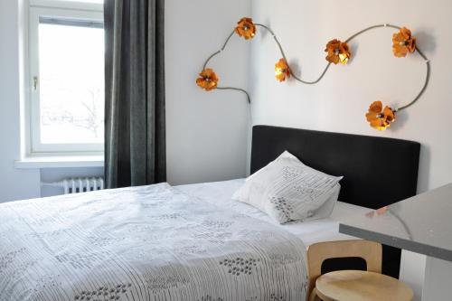 a bedroom with a bed with flowers on the wall at Stylish studio in the centre in Helsinki