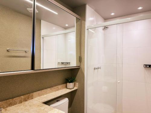 a bathroom with a shower and a sink at Ribeirão Premium Apogeo in Ribeirão Preto