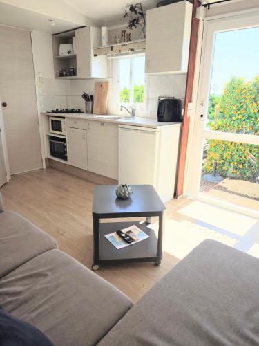 a living room with a couch and a table at Casa Azul-Tiny house with fantastic view, big outdoor space and pool in Silves