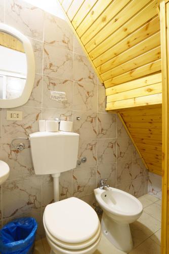 a bathroom with a toilet and a sink at CaTorre 14 in Riomaggiore