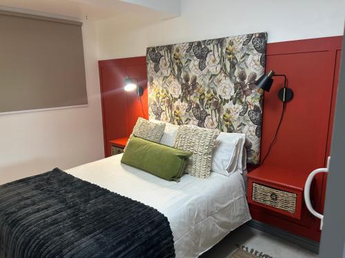 a bedroom with a bed with a red headboard at Private big Apartment in Eversdal