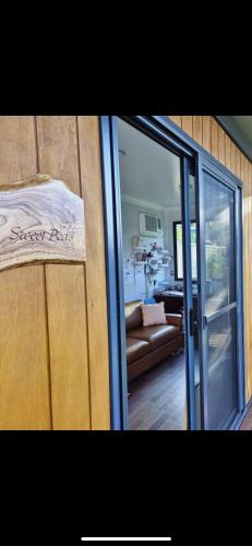 a room with a sliding glass door and a living room at Scrub n bush in Bohena Creek
