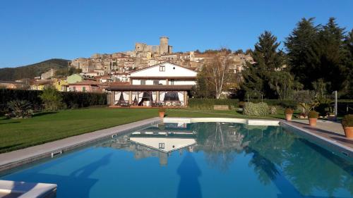 a swimming pool in front of a house at Il Casale di Riardo Luxury B&B in Riardo