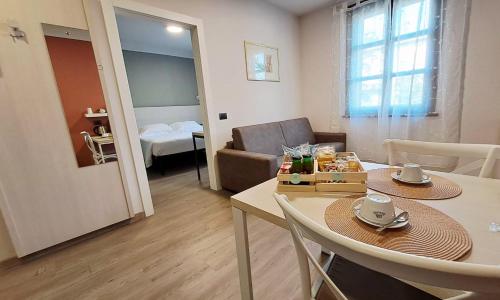 a living room with a table and a couch at DUCATO HOTEL e RESIDENCE in San Polo