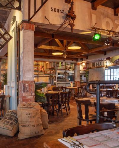 a restaurant with tables and chairs in a room at Hotel Loco in Lievelde