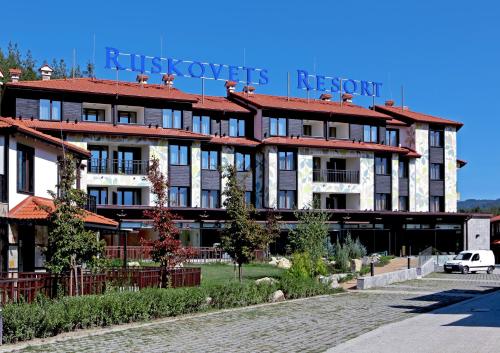 a building with a sign on top of it at Ruskovets Thermal SPA & Ski Resort in Bansko