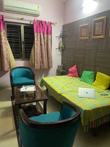 a room with two beds and a table and a laptop at Abode of Peace in Esperance
