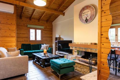 a living room with a couch and a fireplace at Pierian Chalets by TETOS - Grand in Velventós