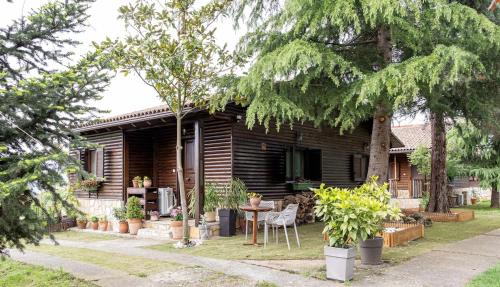 a house with a table and chairs in front of it at Pierian Chalets by TETOS - Grand in Velventós