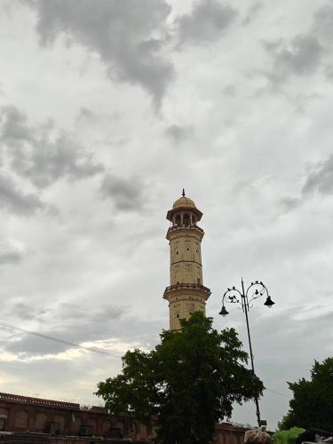 a clock tower on top of a building at The Pink Nest - Backpackers Abode in Jaipur
