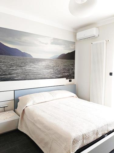a bedroom with a large bed with a view of the water at Playadeivo in Pineto