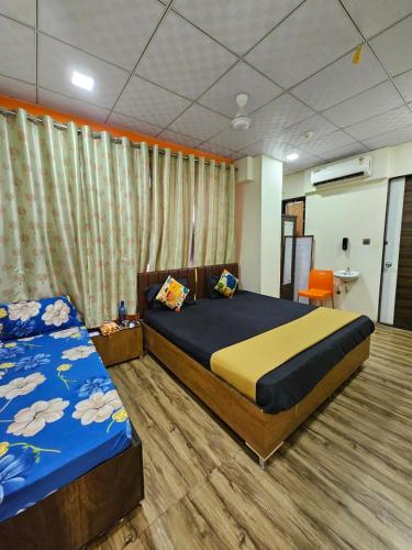 a bedroom with two beds in a room at hotel orange palace in Surat