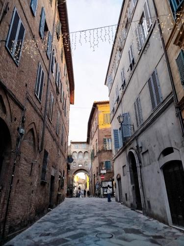 an alley in an old city with buildings at A Casa di Mavina - Luxury Stay in Siena