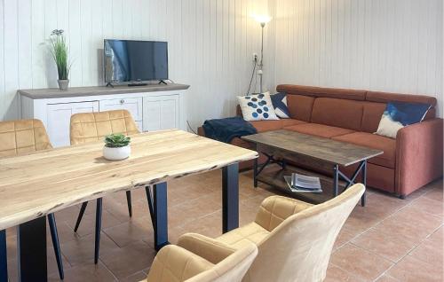 a living room with a table and a couch at Fh Pink in Warenthin