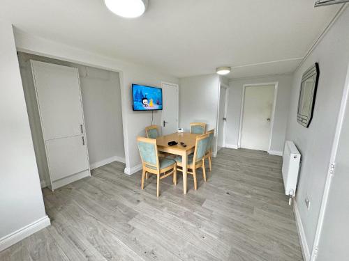 a dining room with a table and chairs at Riverside Cottage in Spalding