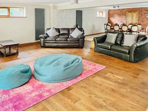 a living room with a couch and a bean bag chair at Grantham House in Grantham
