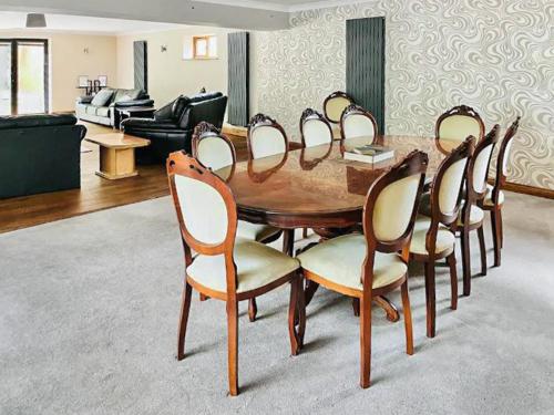 a wooden table and chairs in a living room at Grantham House in Grantham