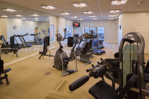 a gym with treadmills and elliptical machines at Escapes! To The Shores Orange Beach, A Ramada by Wyndham in Orange Beach