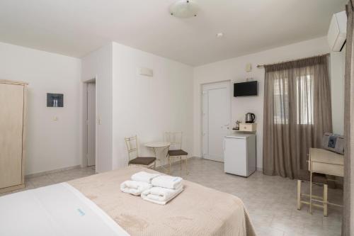 a bedroom with a bed with towels on it at Livanios Studios in Adamantas