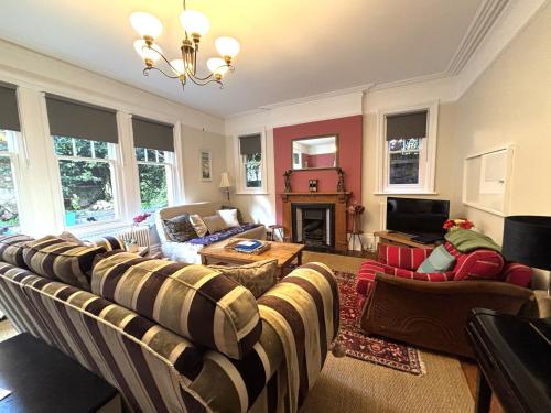 a living room with a couch and a fireplace at Silverdale Holiday Apartments in Eastbourne