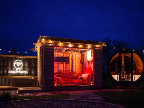 a small house with lights on it at night at Bailey Huts in Litton