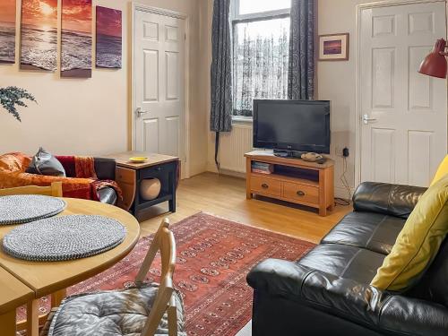 a living room with a couch and a television at The Salthouse in Sunderland