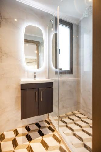 a bathroom with a sink and a mirror at The Four Villas Hanioti by Luxlikehome in Hanioti