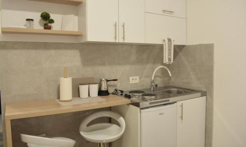a small bathroom with a toilet and a sink at Nanchev Apartments in Gevgelija