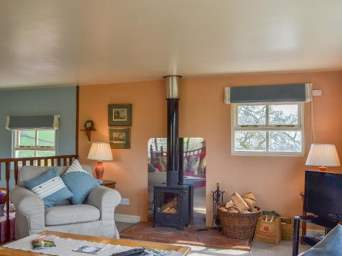 a living room with a couch and a wood stove at Bugatti House in Bosbury