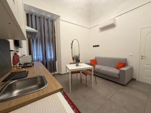 a kitchen and living room with a couch and a sink at A ca' de Lisetta in Albenga