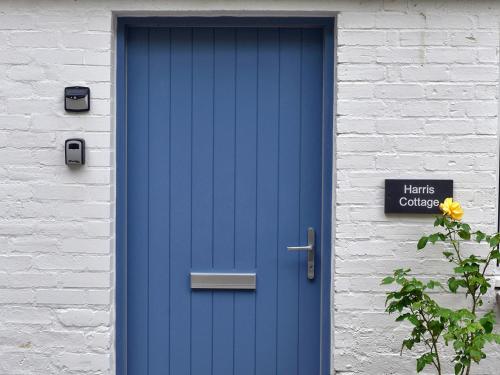 a blue door on the side of a building at Harris Cottage - Uk40056 in Aberfeldy
