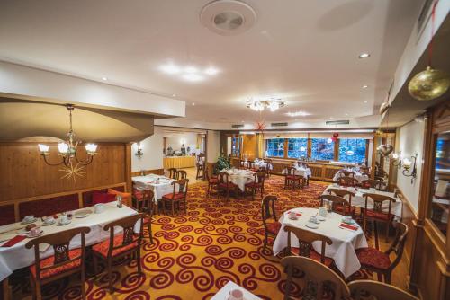 a restaurant with tables and chairs in a room at Landhotel Goldener Acker in Morsbach