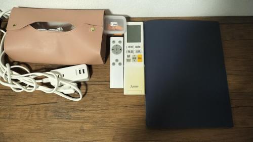 a nintendo wii game controller and a book on a table at 103個室元芸者の隠れ宿湯河原 in Yugawara