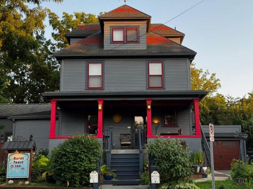 a gray house with a red trim at Burnt Toast Inn and Washington House in Ann Arbor