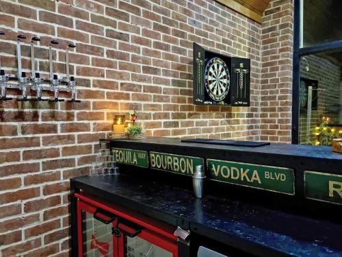 a dart board on the wall of a brick wall at Clamp Farm Barn in Stowmarket