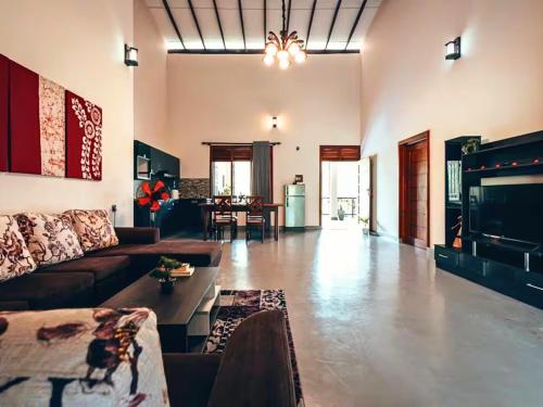a living room with a couch and a table at Spacious 2 Bedroom Apartment with Lake View in Tangalle
