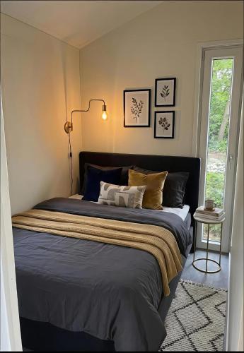 a bedroom with a bed with blue sheets and a lamp at The Wellness View! in Hoogersmilde