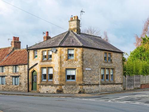an old brick building on the side of a street at Ryegate Cottage in Helmsley