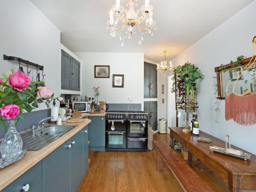 a kitchen with a sink and a stove top oven at Ryegate Cottage in Helmsley