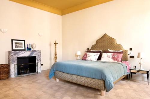 a bedroom with a large bed and a fireplace at Elegant Seafront Apartment in Ostia in Lido di Ostia