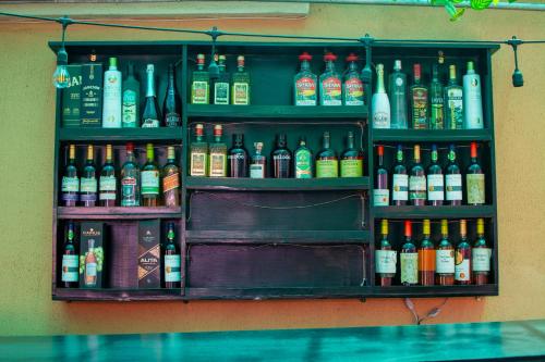 a shelf filled with lots of different types of alcohol at Beulah House Lounge in Ibadan