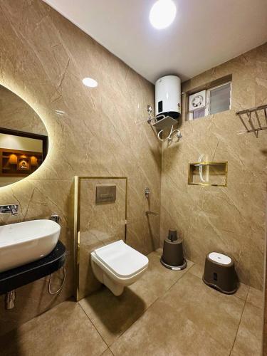 a bathroom with a toilet and a sink at Vrs Homestay in Mayiladuthurai