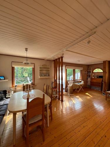 a living room with a table and a dining room at Swedish cottage near ocean in Norrtälje