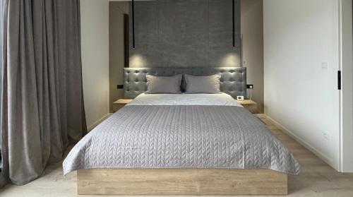 a bedroom with a large bed with a large headboard at ANON Mures in Livezeni